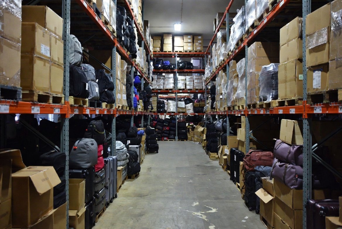 Stacked luggage and travel goods in a Singapore wholesale warehouse